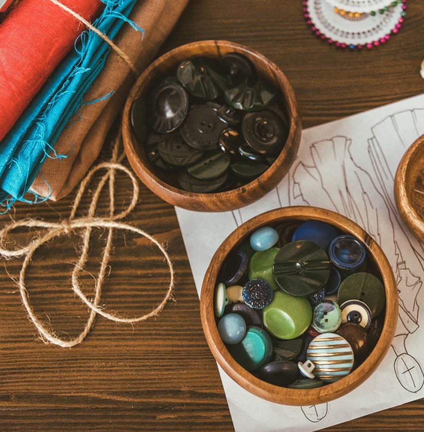 Arts and crafts supplies laid out in two bowls across a table.