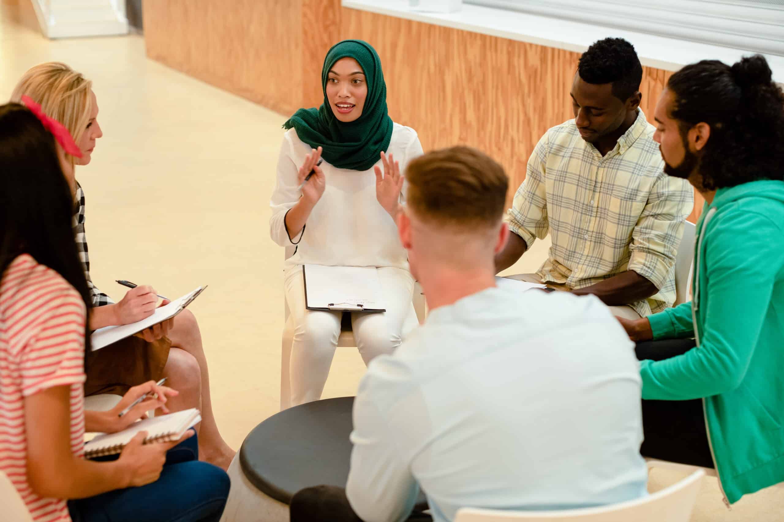 Diverse people sitting in a group having a conversation