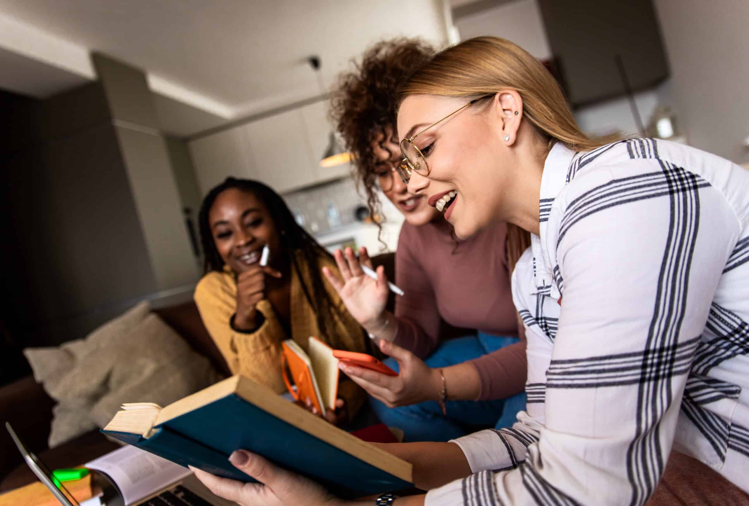 Women read a book together